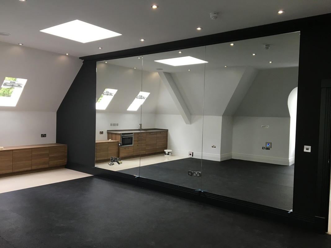 Frameless glass wall dividing loft conversion in Holborn