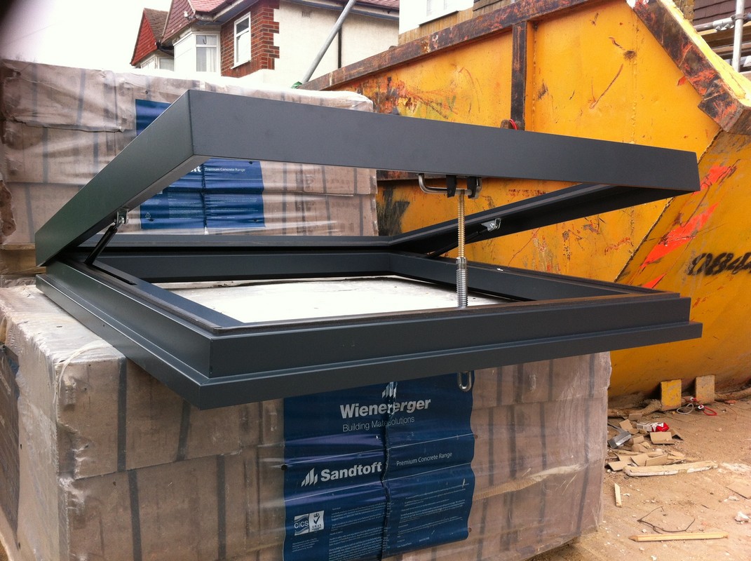 Opening flat roof skylight in anthracite grey installed in Holborn