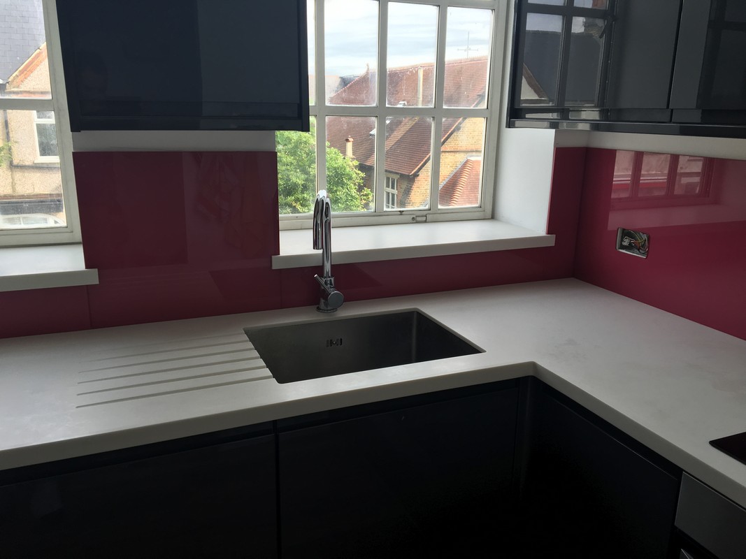 Deep plum coloured glass splashback in modern Holborn kitchen