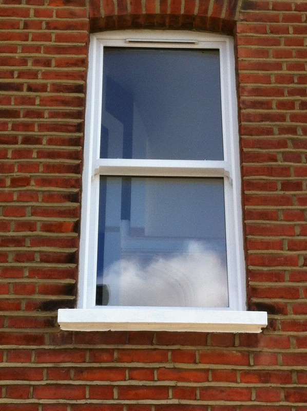 uPVC sash window on Victorian red brick house in Holborn